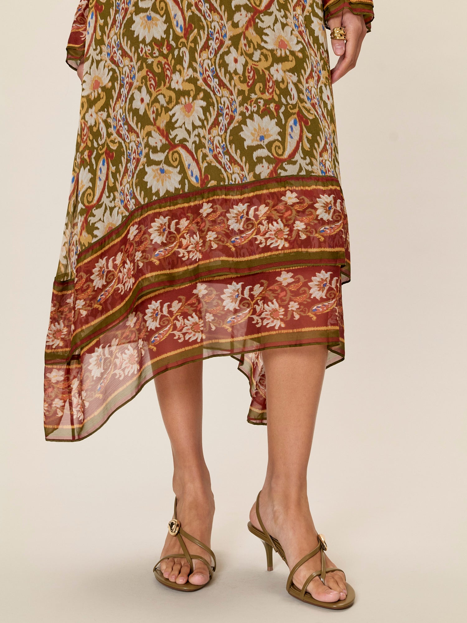 Woman wearing a patterned dress with a neutral background